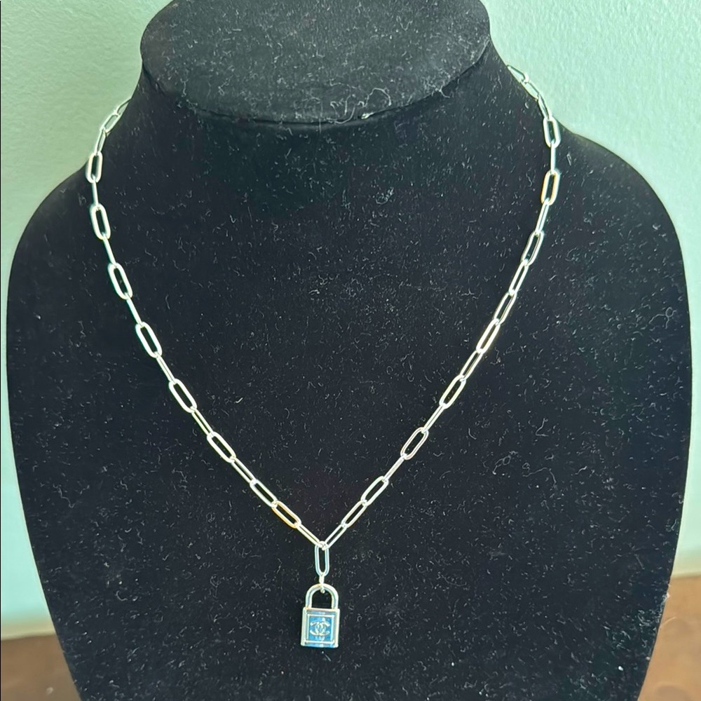 Fashion sterling silver paperclip chain with an authentic Chanel lock charm